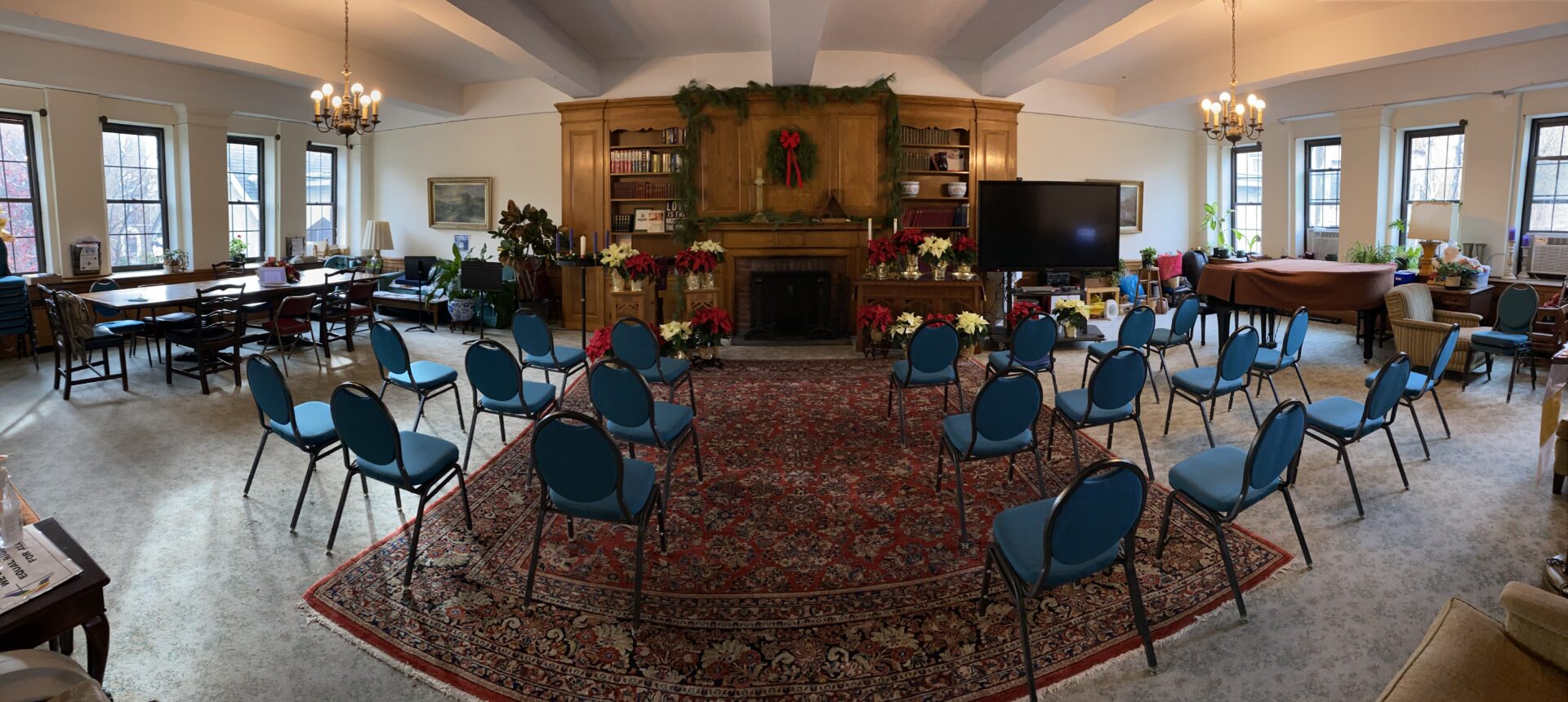 An empty room with blue chairs and flower decoration