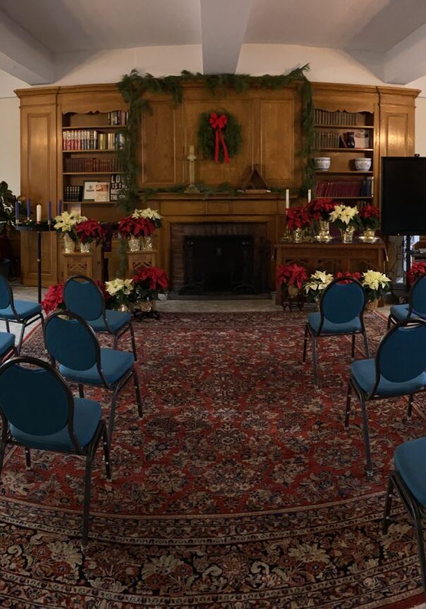 An empty room with blue chairs and flower decoration